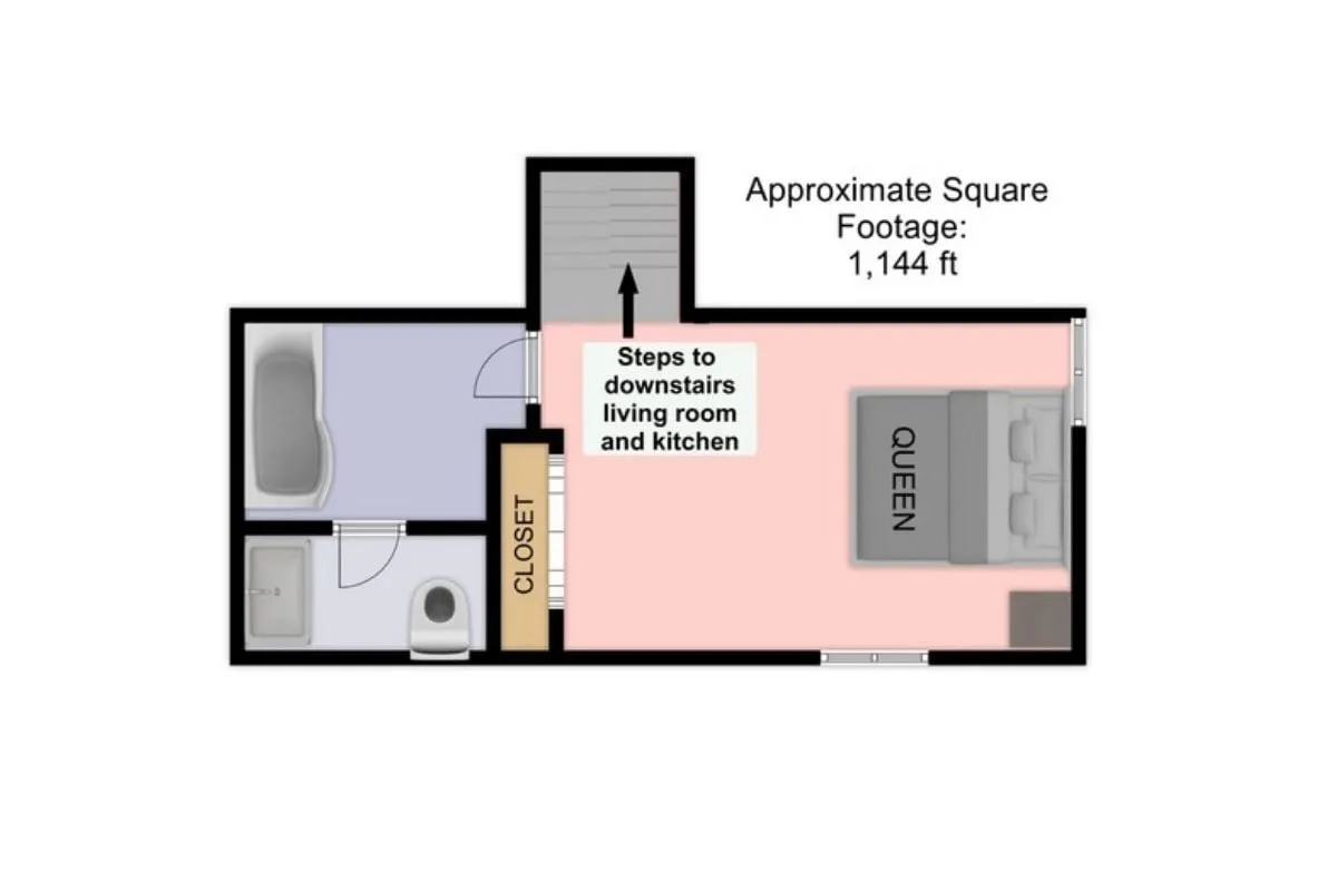 A comfortable open loft bedroom featuring a queen bed, a stairway leading up from the living area below, a practical closet for storage, and a visible doorway leading to the en suite bathroom. The space is bright and open, with the half-wall visible to emphasize the open-concept nature of the suite.